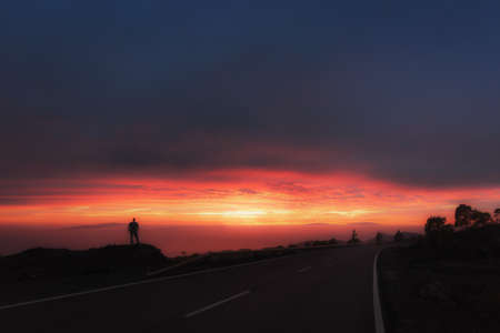 sunset with very warm colors and clouds where you can see the sphere of the sun