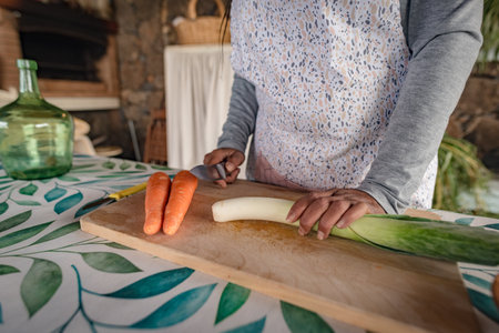 black woman with glasses teaches online with her mobile phone cooking classes from homeの写真素材