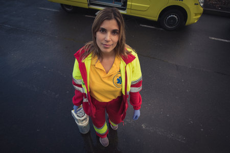 a young sanitary woman in an ambulance prepare to do an emergency serviceの写真素材