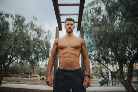 young man exercises with face mask outdoors