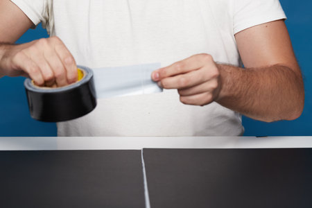 Anonymous person using black cellophane on a table with black cardboard in a study sessionの写真素材