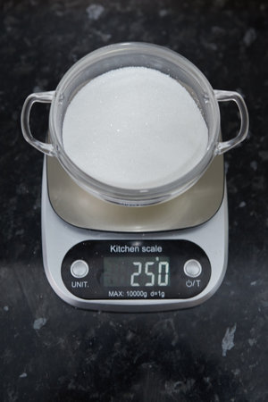 Scales marking the weight in grams of a bowl of sugar.の写真素材