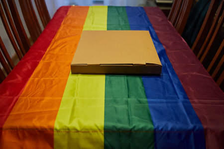 Cardboard box on a table with a lgtbi flag tableclothの写真素材