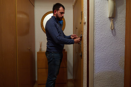 Close-up of a hand opening the front door of the houseの写真素材