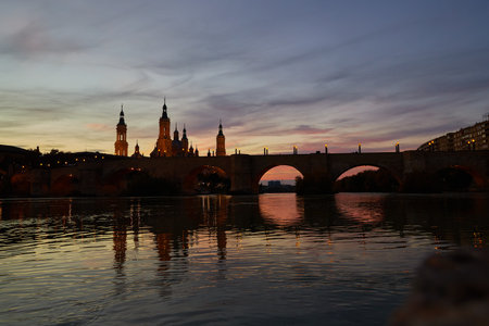 Beautiful landscape of the basilica del pilar and the ebro river at sunsetの写真素材