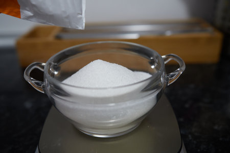 Scales marking the weight in grams of a bowl of sugar.の写真素材