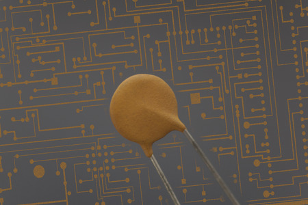 Electronic capacitor in black background