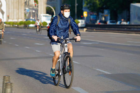 Madrid, Spain - 22 May 2020: Young man in bicycle and mask because of the Covid-19のeditorial素材