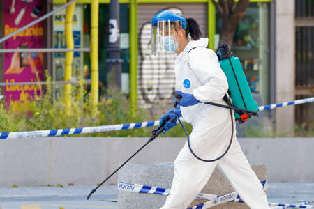 Madrid, Spain, 22 may 2020: Working woman disinfecting the streets with special equipment to combat the coronavirus.のeditorial素材