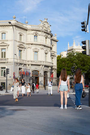 Madrid, Spain - June 15, 2020: People crossing the street by the crosswalk. People wear a mask to protect themselves from the Covid-19のeditorial素材