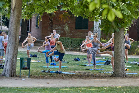 Madrid, Spain - July 7, 2020: A group of people receive a yoga class in a public parkのeditorial素材