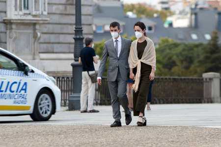 Madrid, Spain - August 8, 2020: Tourists and walkers walk through the city of in a sunset in the city of Madrid. People wear a mask to protect yourself from Covid-19のeditorial素材