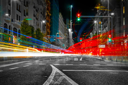 Madrid, Spain - September 27, 2020: -Long exposure night photography of Gran Via street in Madrid. Trails of lights from cars and traffic lights.のeditorial素材