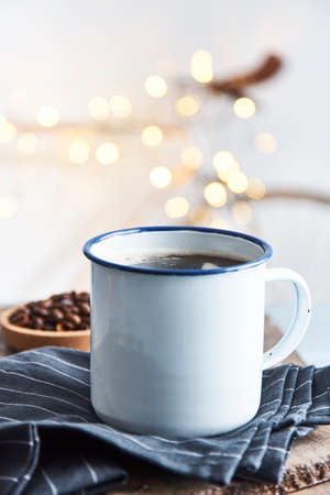 Fresh tasty coffee in metallic cup on served on table in cafeteria.の写真素材