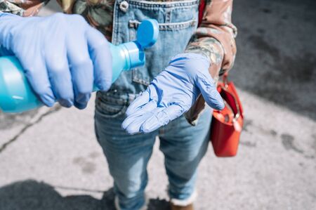 Women's hands wearing medical gloves using hand sanitizer gel . healthcare and medical....