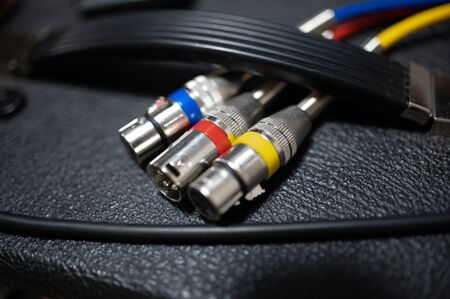 Color-differentiated audio cables on an amplifier.Music concept