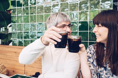 Happy friends cheering at a bar celebrating friendship.Copy space.Happy people conceptの写真素材