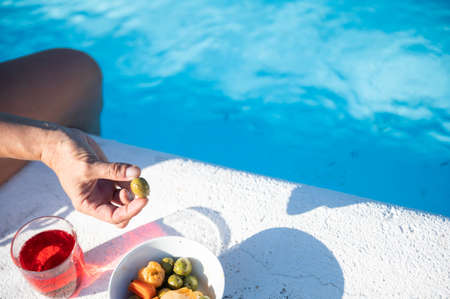 Getting your strength back with some natural snacks and a drink by the pool. Copy space.Vacations conceptの写真素材