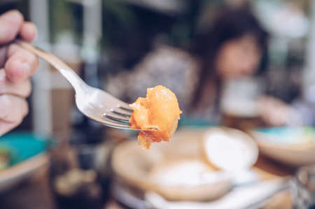 Close up of a fork with gnocchi during a friend's meal.Unfocused background. Copy space. Enjoying the life with friendsの写真素材