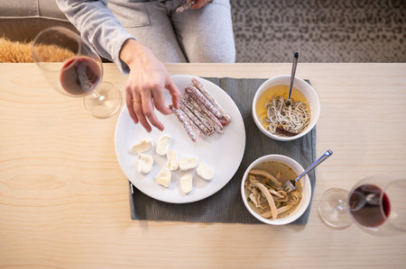 Woman eating tasty food during an intimate meal at home