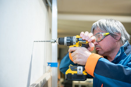 Caucasian man making repairs in his workshop.Professional concept