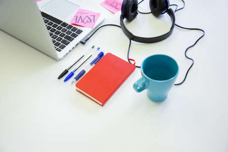 Office desk workplace with laptop, notebook, office supplies. Working top view concept.の写真素材