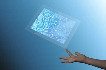 Technology on a childrens finger in a blue backgroundの写真素材