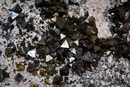 Close up on a triangular magnetite mineral stone inserted in a rock