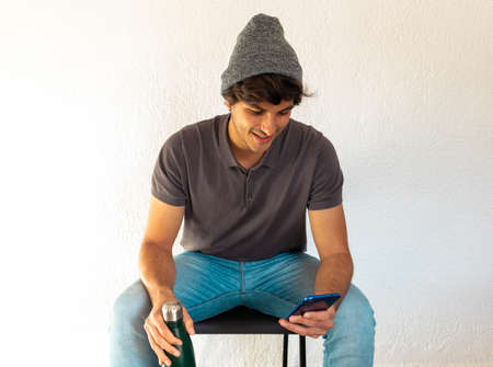 side view of high school or college student studying and writing in a notebook on a desk with a...
