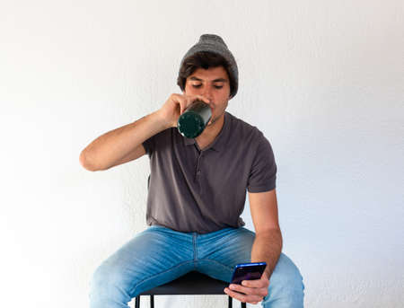 side view of high school or college student studying and writing in a notebook on a desk with a laptopの写真素材