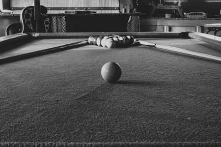 Pool table and guitar in a home environment, black and whiteの写真素材