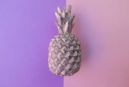 silver pineapple on a half purple and half pink backgroundの写真素材