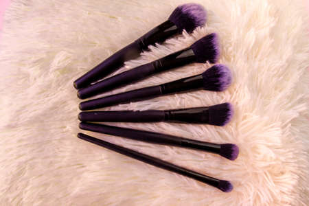 set of black make-up brushes on white hairs background