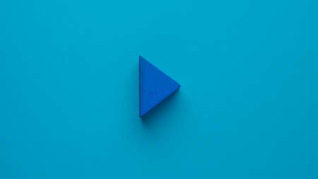 Blue triangle in the shape of the play buttonの写真素材