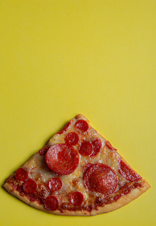 pepperoni pizza on yellow color backgroundの写真素材