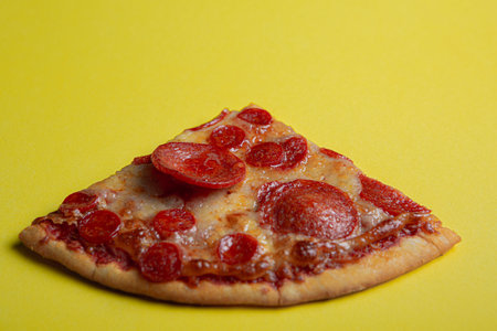 pepperoni pizza on yellow color backgroundの写真素材