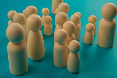 Groups of wooden tokens simulating people of different types grouped in a demonstrationの写真素材