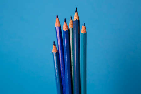 Wooden pencils of different shades of blue on a blue backgroundの写真素材