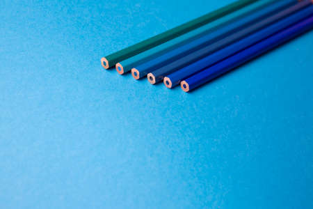 Wooden pencils of different shades of blue on a blue backgroundの写真素材
