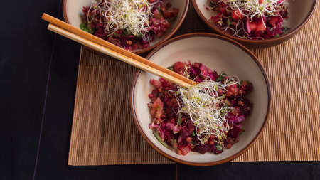 Lentil, beet, and sprout salad in three individual bowls