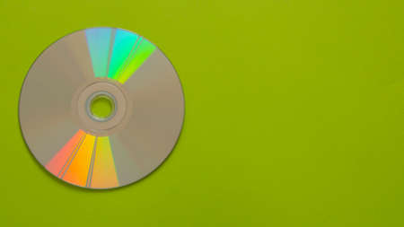 Compact disc on a green colored backgroundの写真素材