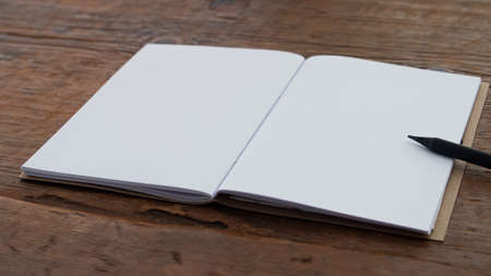 Small notebook with blank pages on a dark brown weathered old wood