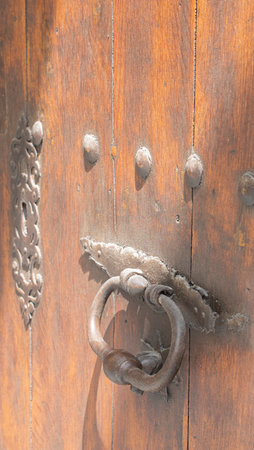 Old wooden door with metal ornamentsの写真素材