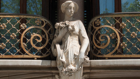 Restored facade of an old building in the center of the city of Olot in Catalonia. Columns and statue of a woman sculpted in stone.の写真素材