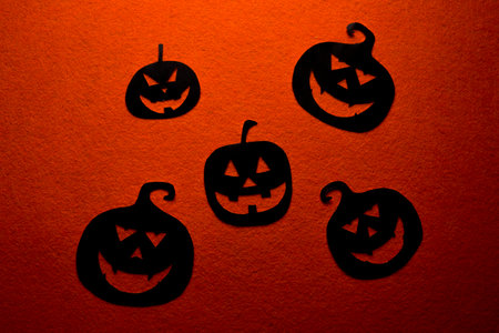 Group of hand painted black pumpkins on a colored backgroundの写真素材