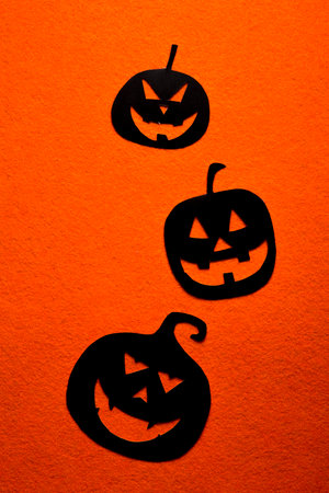 Group of hand painted black pumpkins on a colored backgroundの写真素材