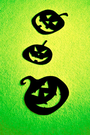 Group of hand painted black pumpkins on a colored backgroundの写真素材