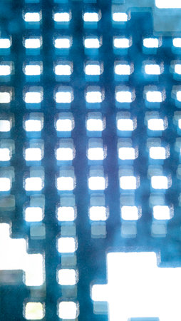 Mosaic pattern of illuminated squares creating a geometric light texture