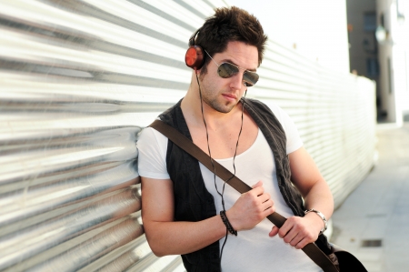 Portrait of young happy man in urban backgroundの写真素材