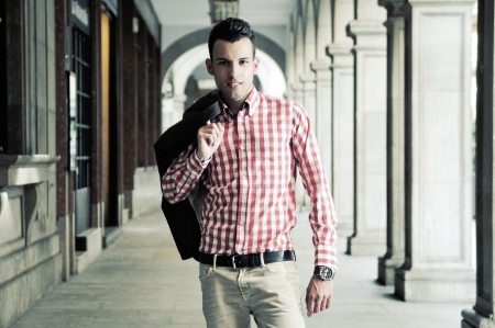 Portrait of a young handsome man, model of fashion, wearing jacket and shirt in urban backgroundの写真素材